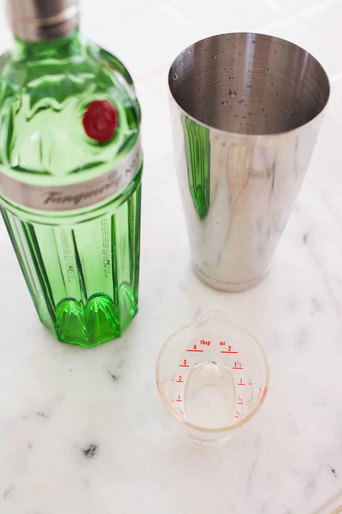 Gin being measured into a cocktail shaker.