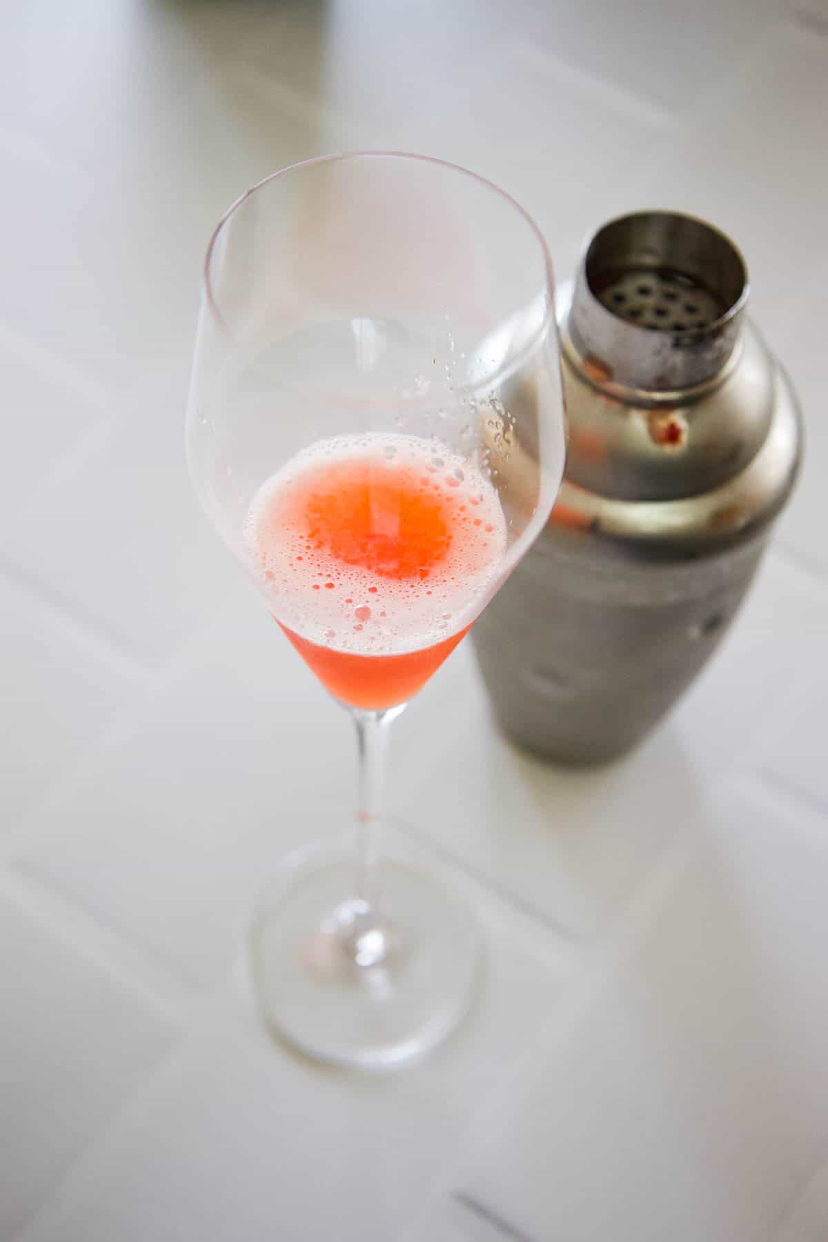 A champagne flute with a mix of strawberries, lemon and St Germain in a champagne flute.