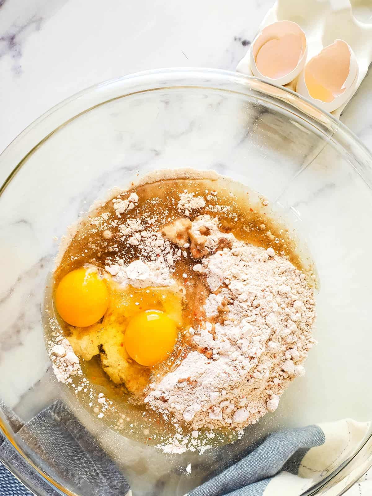 A large glass bowl with ingredients to make cake mix cookies.