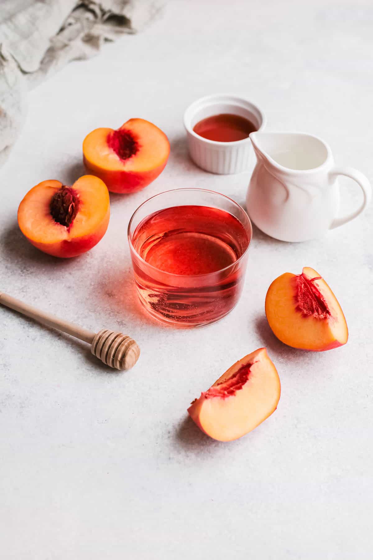 Peach Frosé ingredients on a grey background.