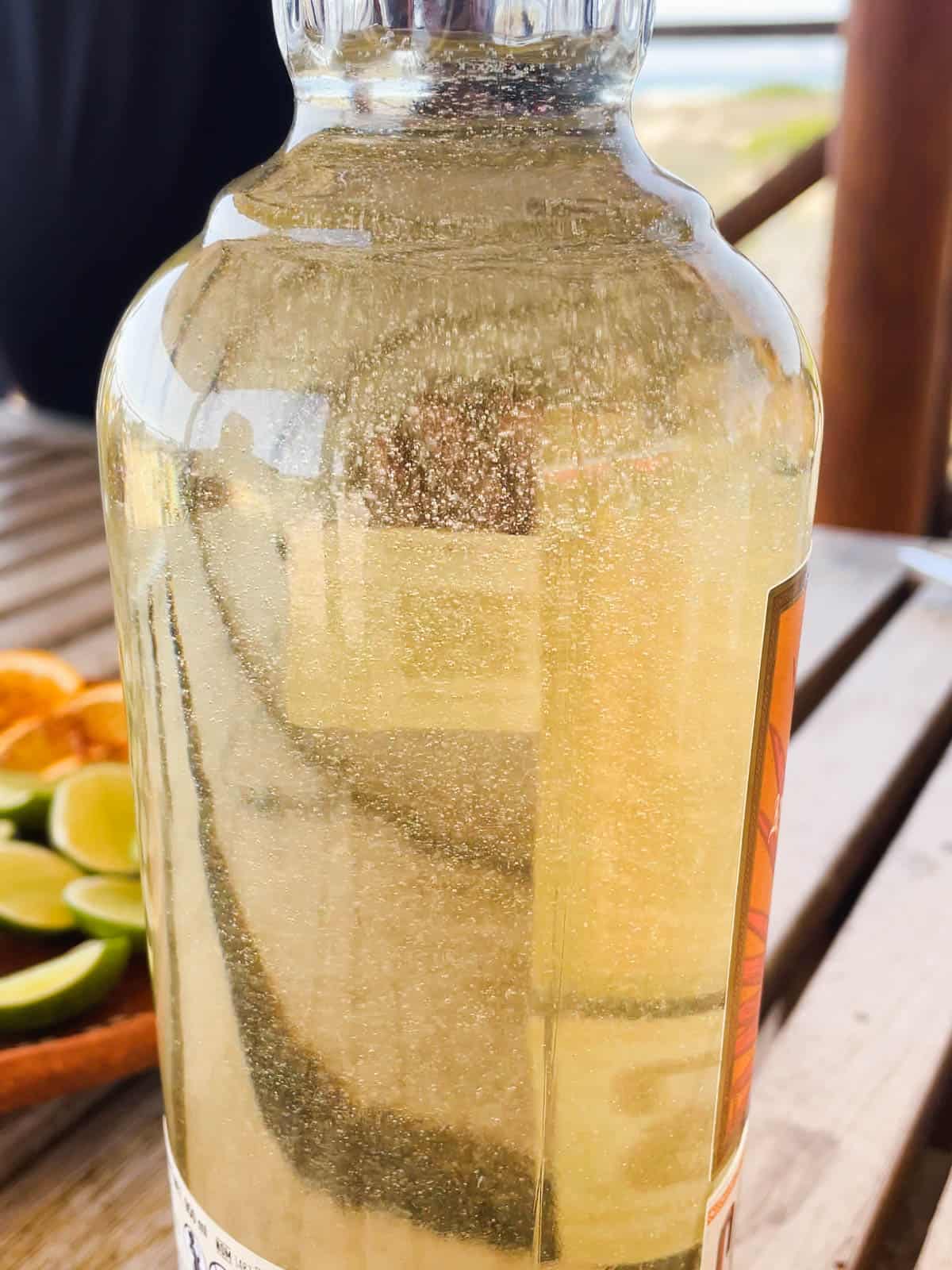 Close up image of bubbles in a bottle of Cazadores Tequila Reposado.