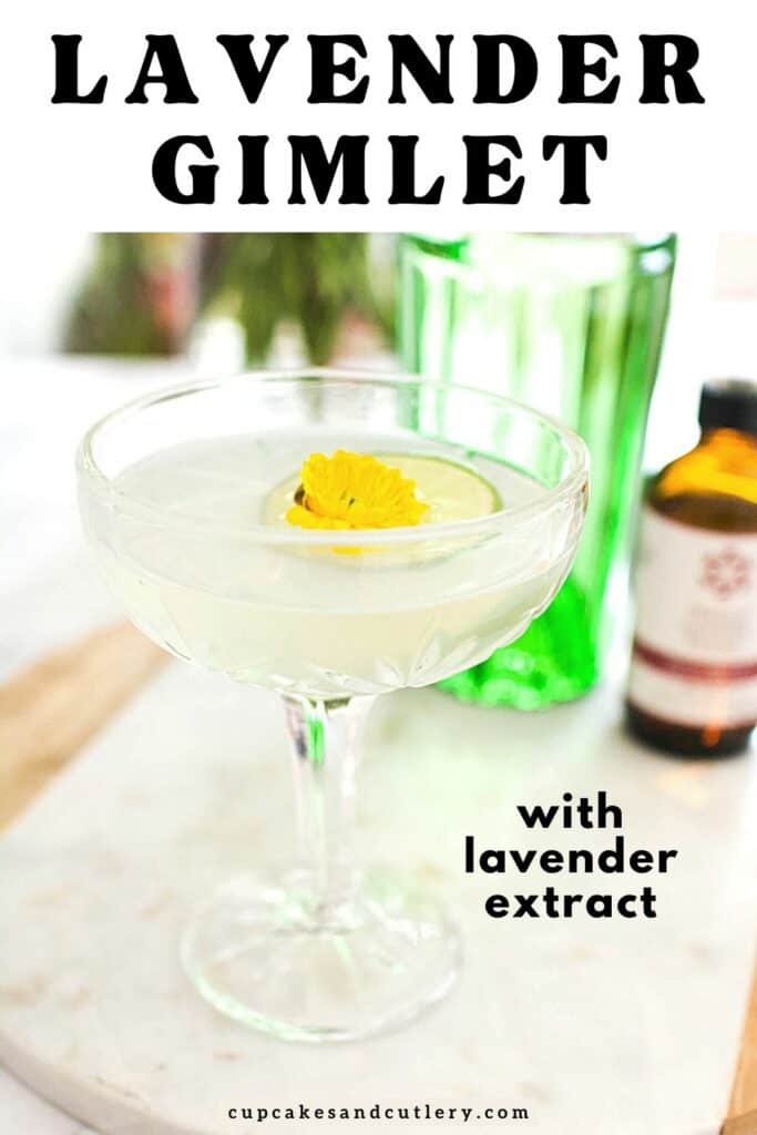 Close up of a lavender gimlet garnished with a lime wheel and edible flower.