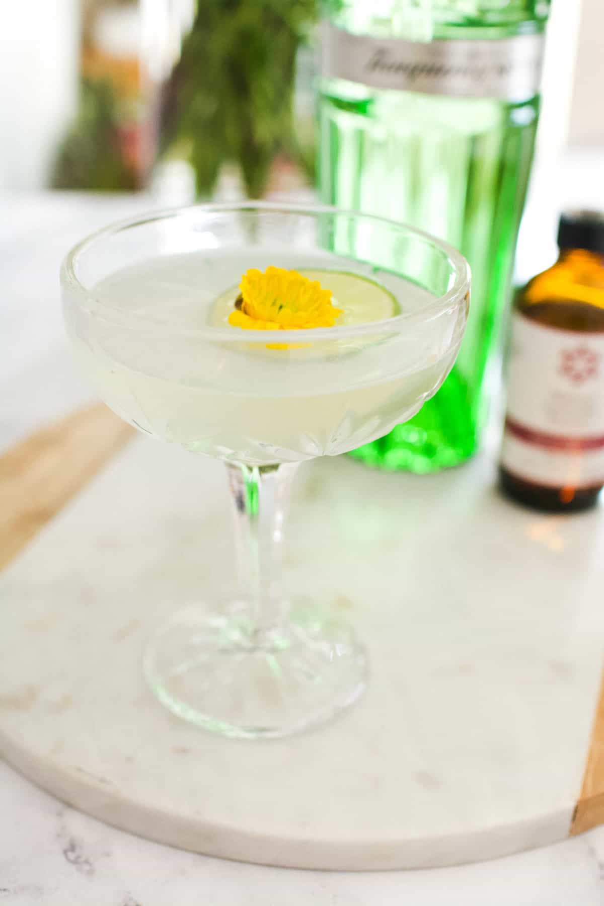 Close up of a lavender gimlet on a marble board.