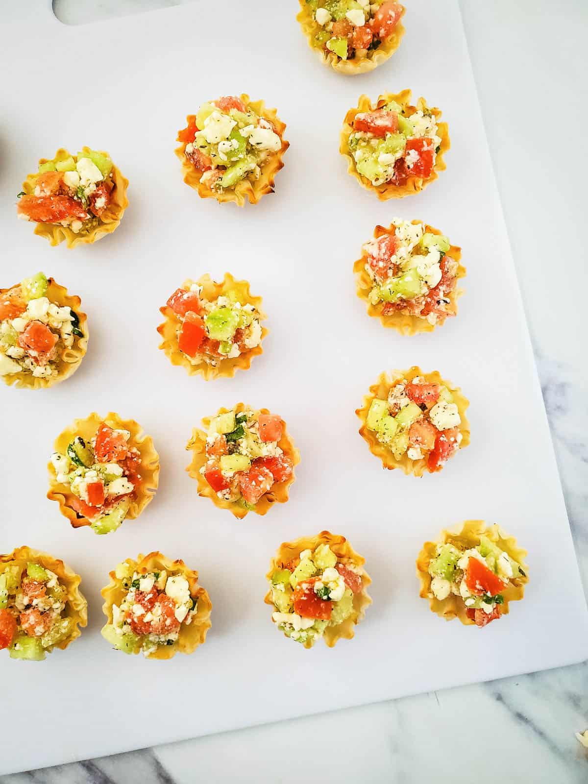 Party appetizers on a white board.