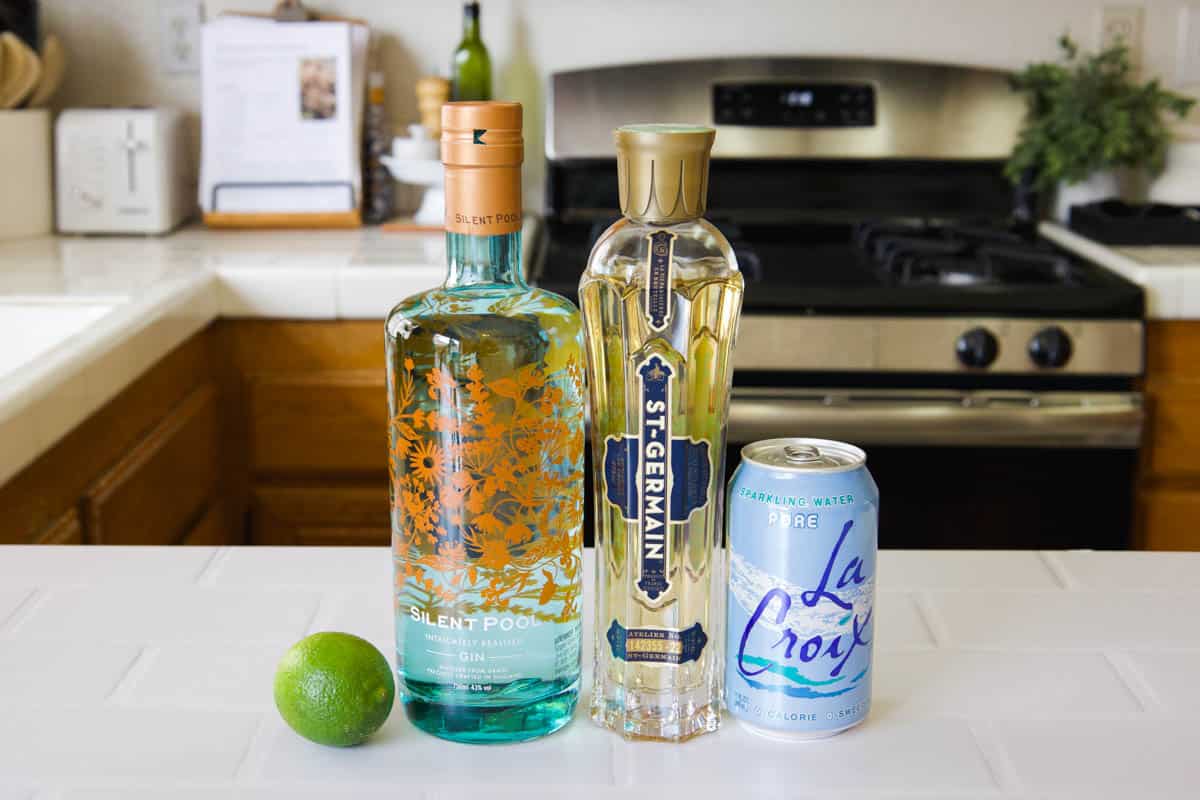 Ingredients for a St Germain Gin Fizz on the kitchen countertop. 