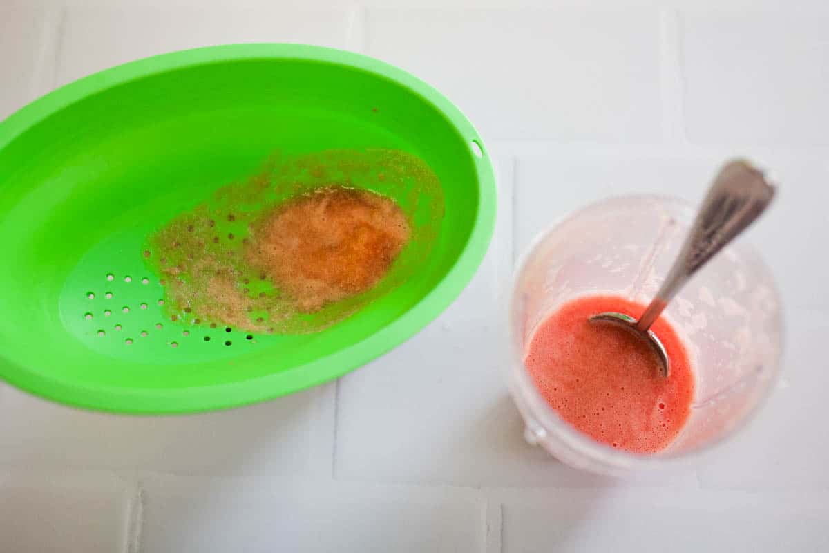 Blended watermelon being strained into juice.