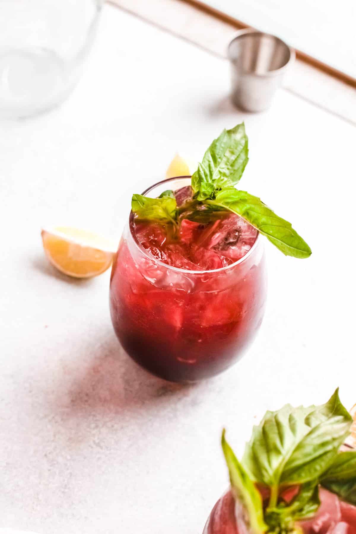 Cherry Moscow Mule garnished with a sprig of fresh basil.