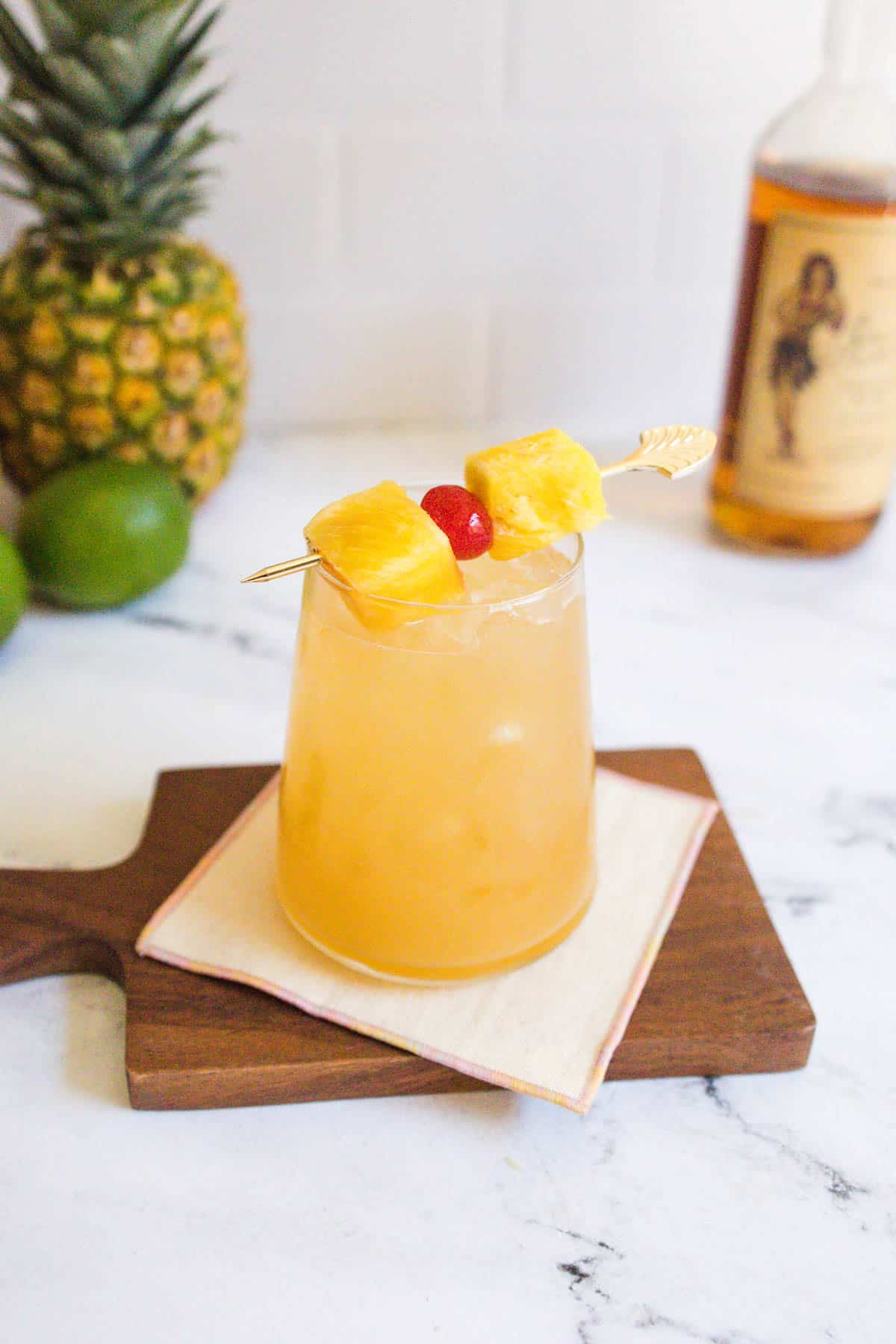 Wine rum pineapple cocktail on a wooden board.