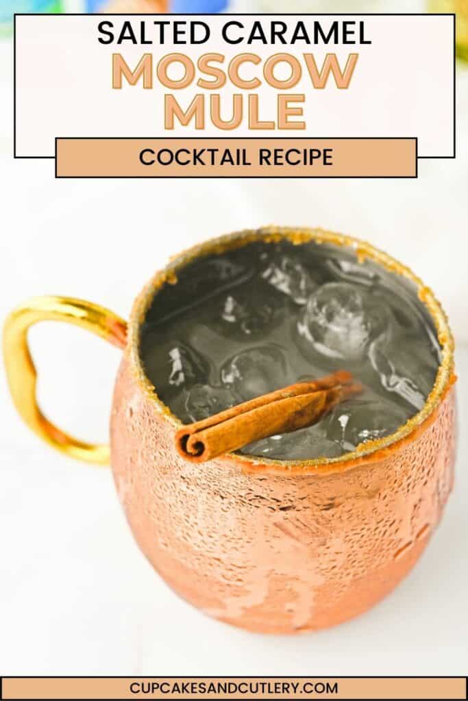 Close up of a Caramel Vodka Moscow Mule in a copper mug garnished with a cinnamon stick.
