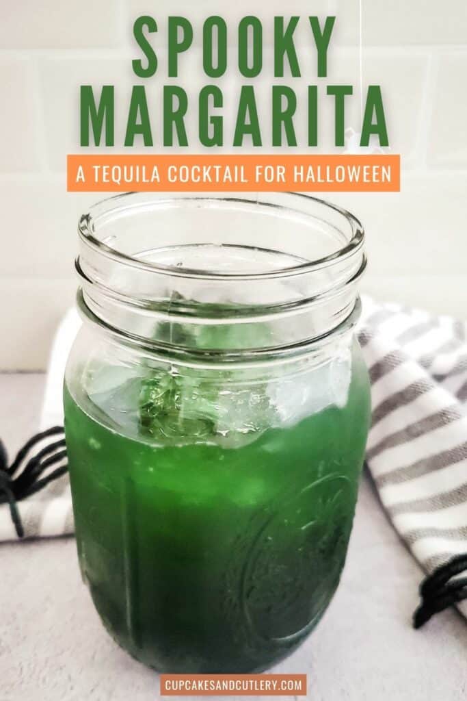 Close up of a green Halloween margarita in a Mason jar.