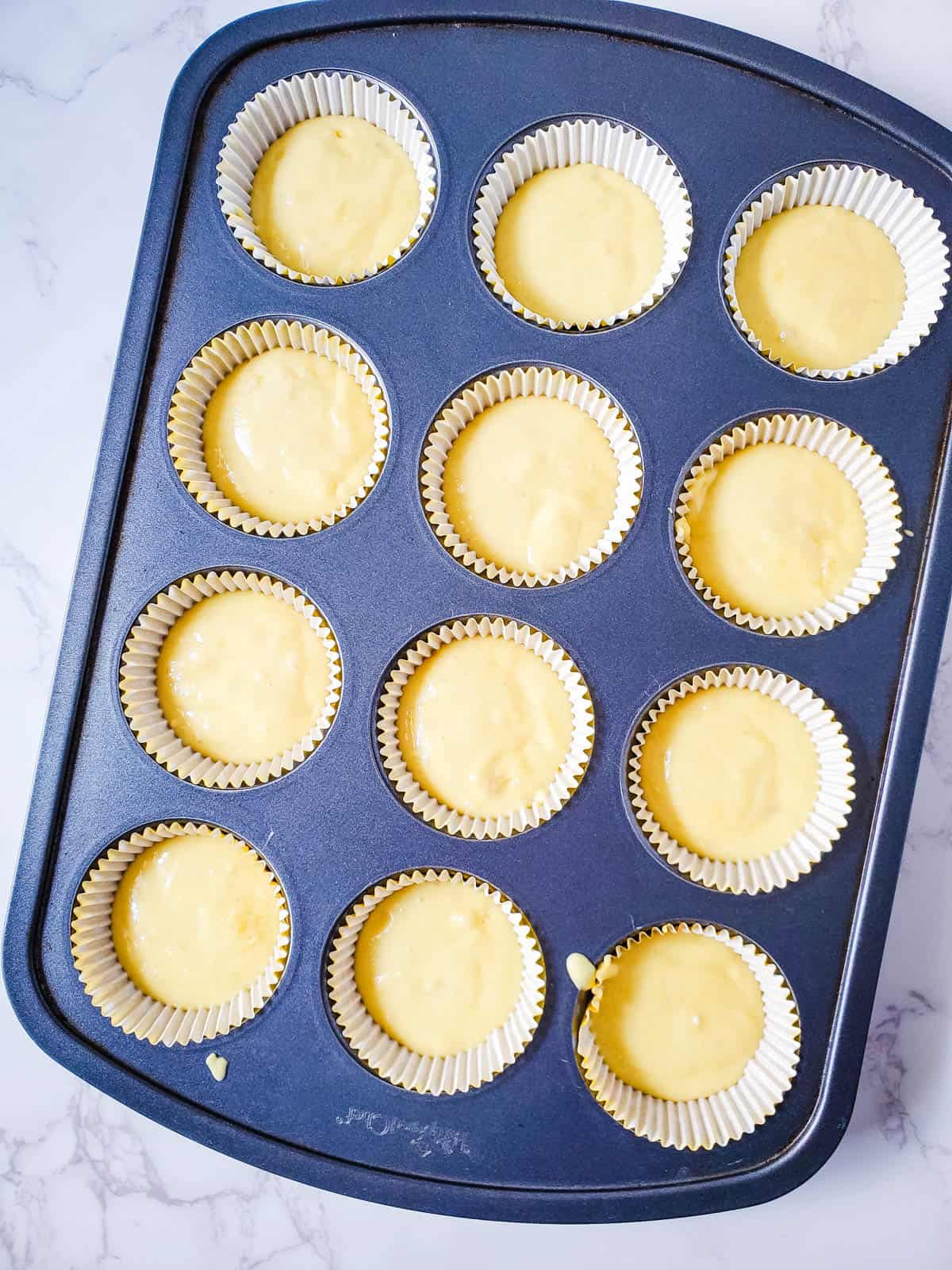 Pina colada cupcake batter in a cupcake pan.