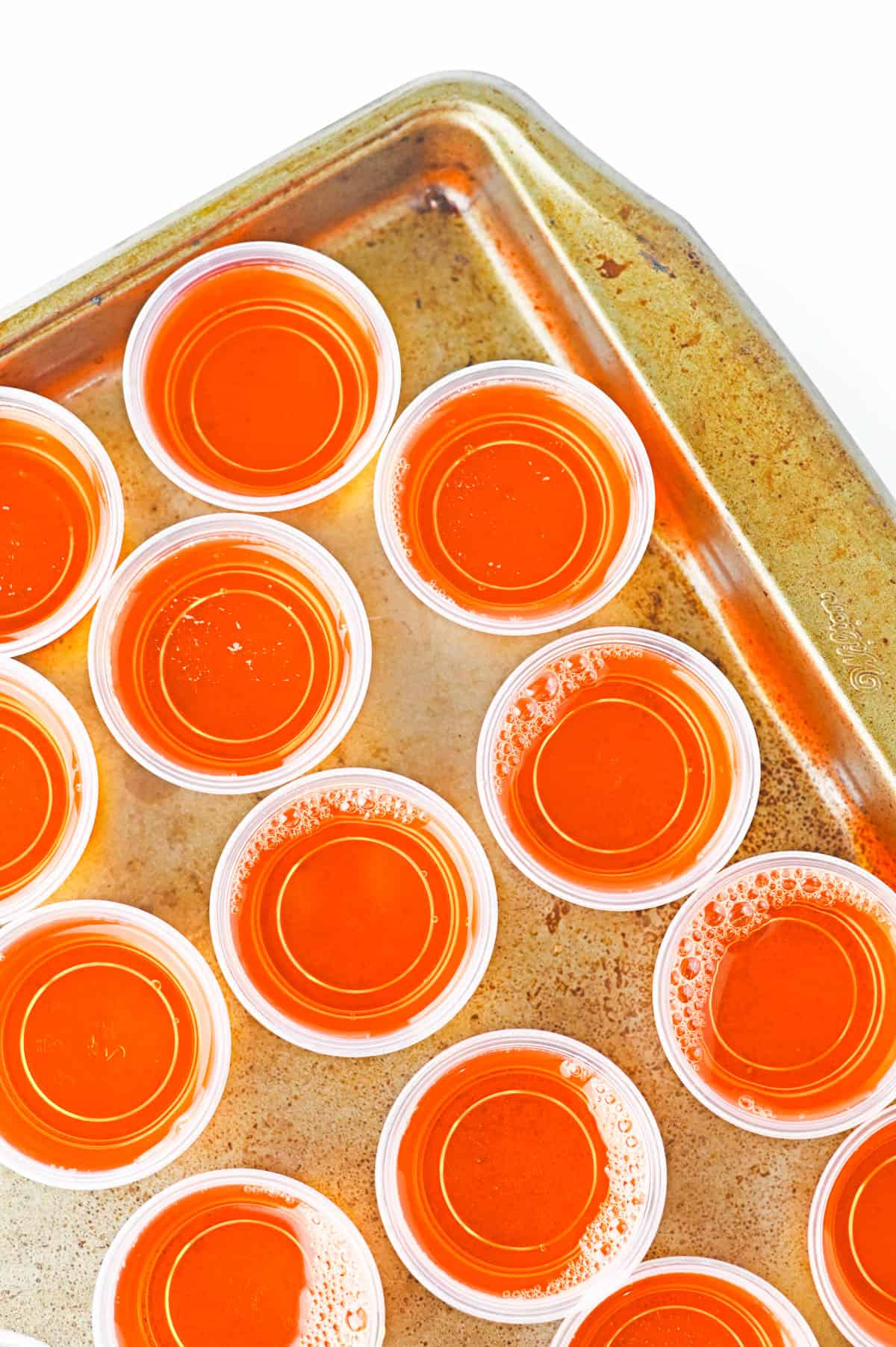A tray of orange Jello shots.