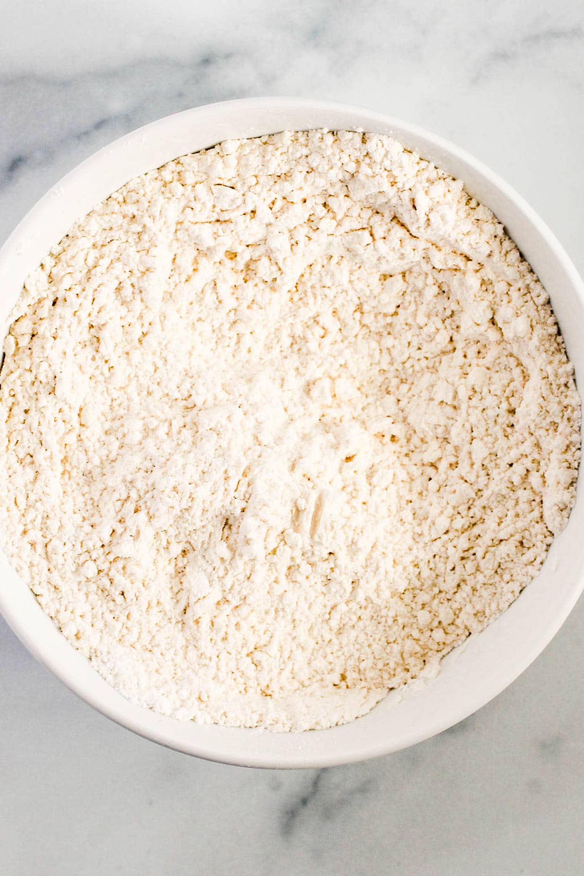 A bowl with dry ingredients to make a giant snickerdoodle cookie.