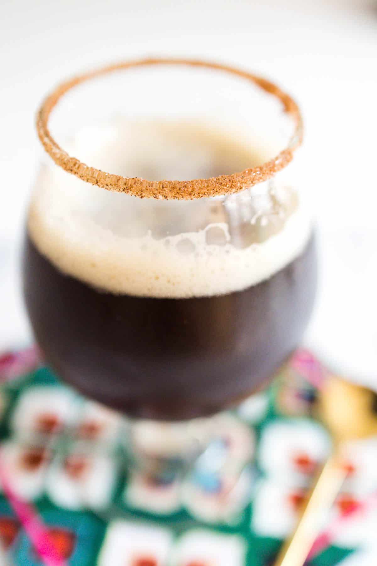 Close up of a coffee cocktail with a cinnamon sugar rim.