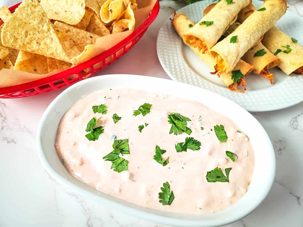 A close up image of sour cream salsa dip.