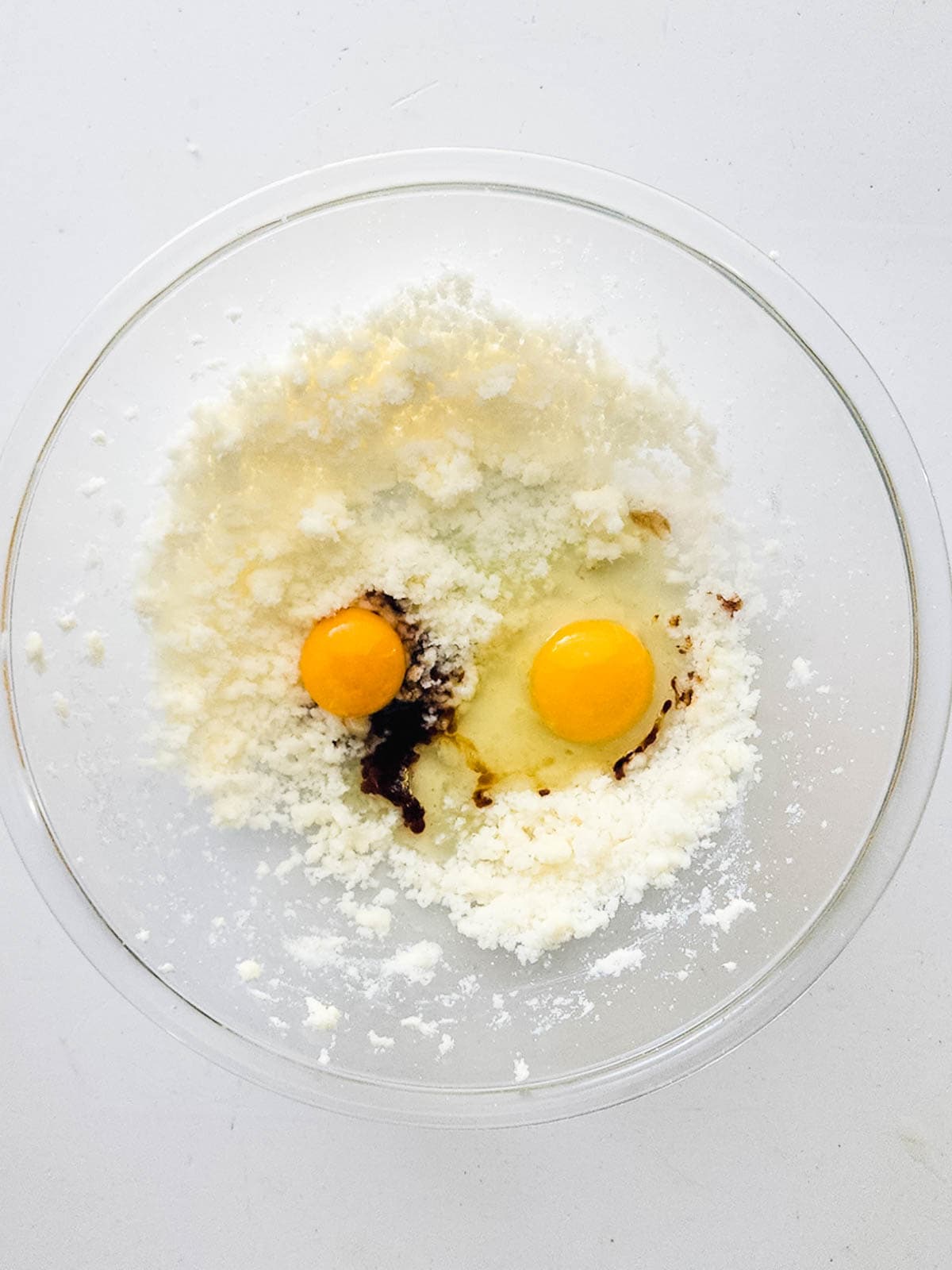 A mixing bowl with ingredients to make hot cocoa cupcakes.