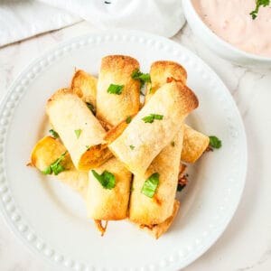 Chicken taquitos with corn tortillas cooked in an air fryer.