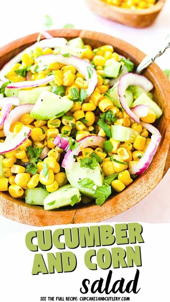 Text: Cucumber and Corn Salad with salad placed on a wooden salad bowl.