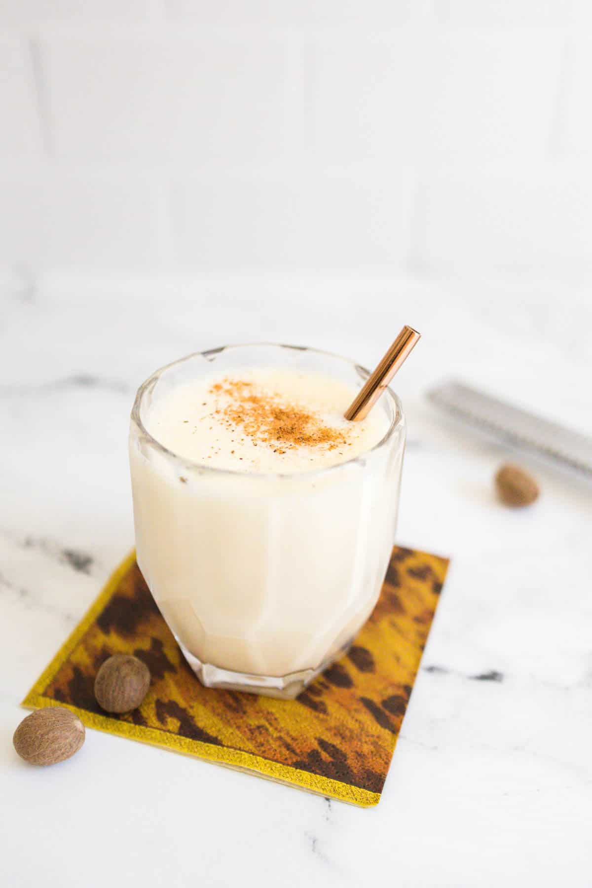 Eggnog Daiquiri garnished with a metal straw and a sprinkling of nutmeg.