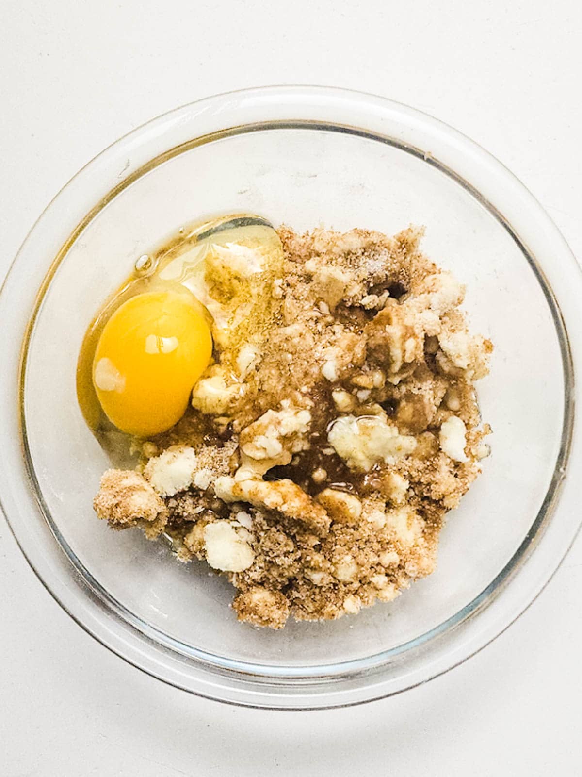 Wet and dry ingredients for white chocolate cookie dough with a raw egg.