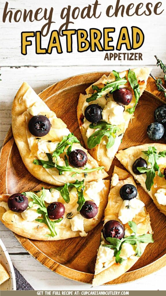 Text: Honey Goat Cheese Flatbread with fresh thyme, arugula, blueberries, and honey drizzle.