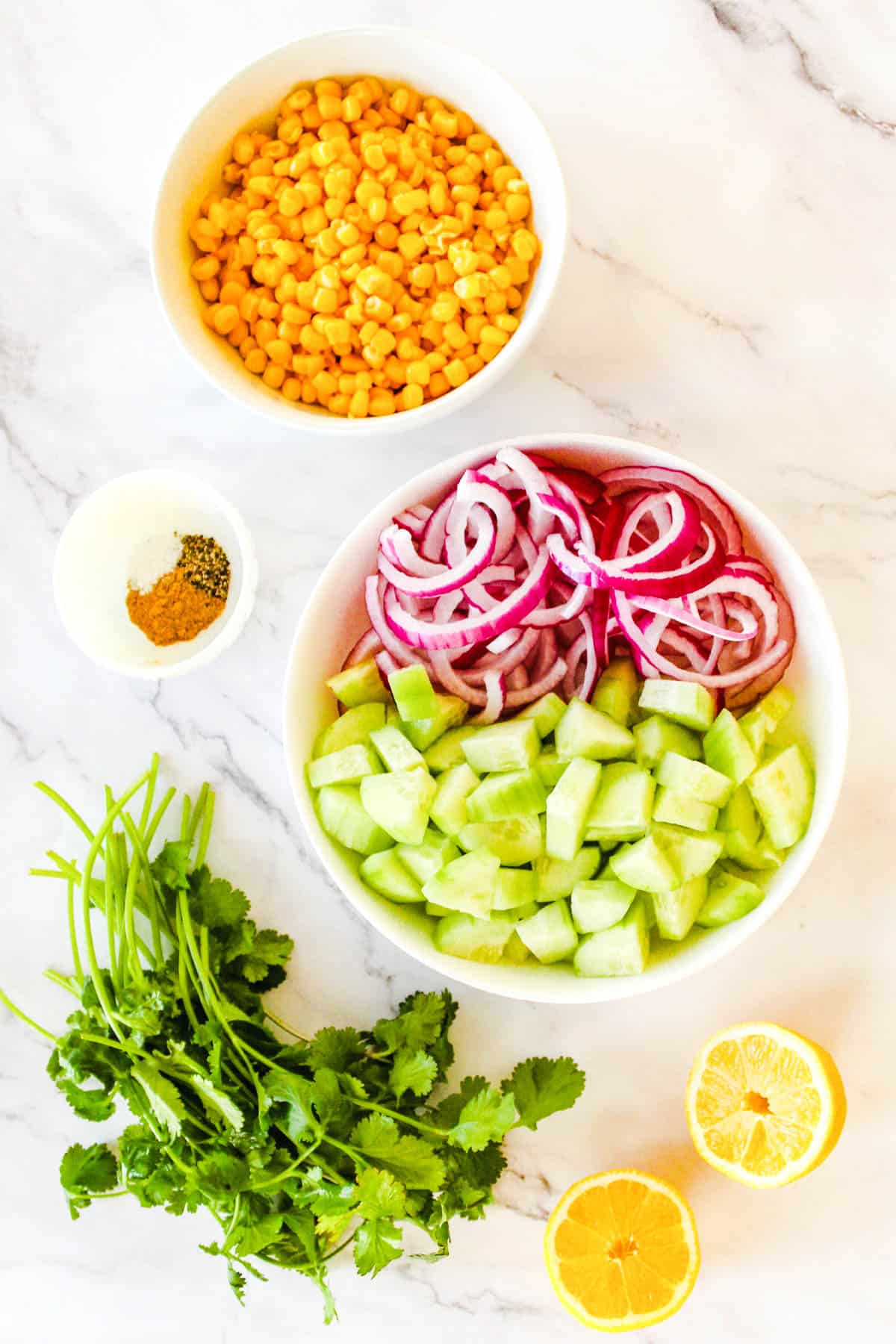 Ingredients needed to make corn and cucumber salad.