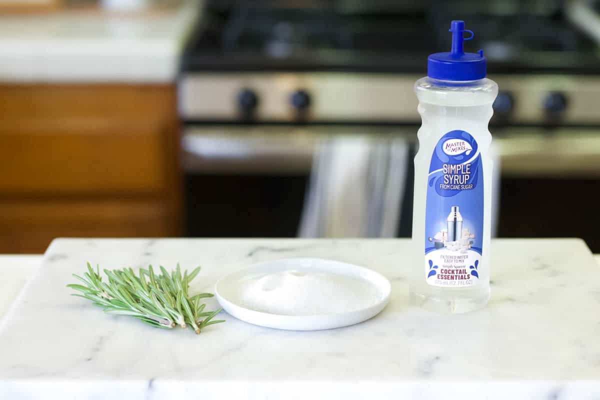 Ingredients needed to make sugared rosemary on the countertop.
