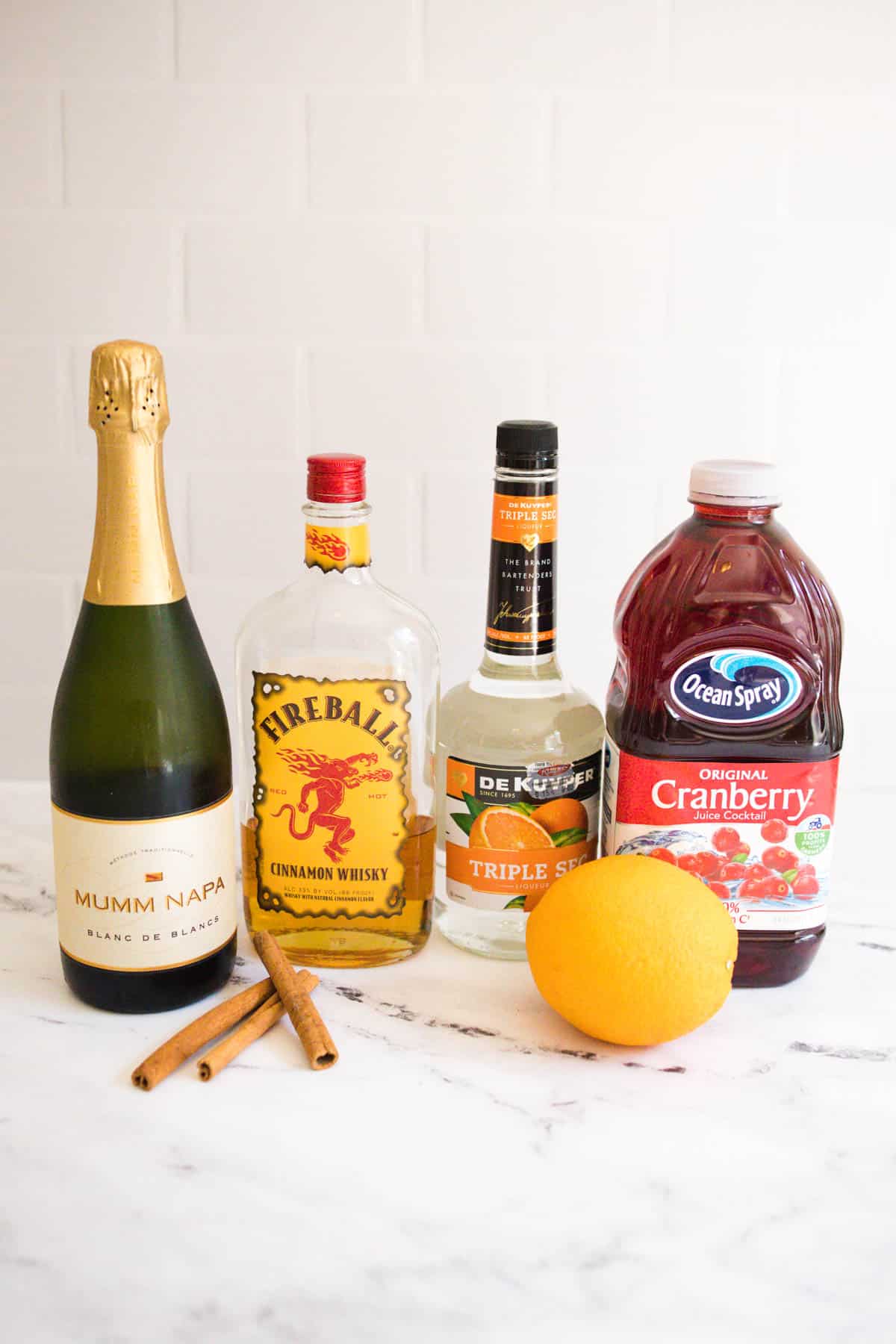 Fireball Sangria ingredients on a white countertop. 