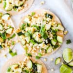 Zucchini and corn tostada with cotija cheese, green onions, and fresh lime juice.