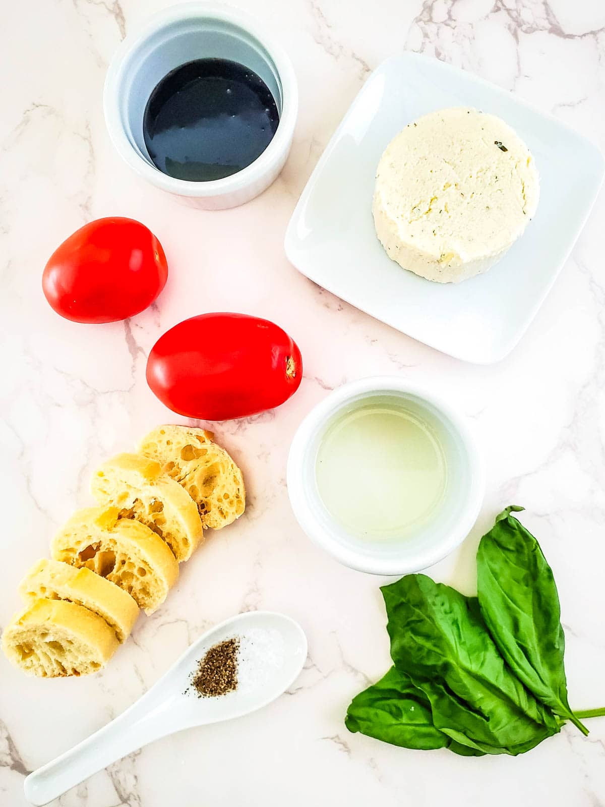 Ingredients to make a boursin dip topped with brushcetta tomatoes.