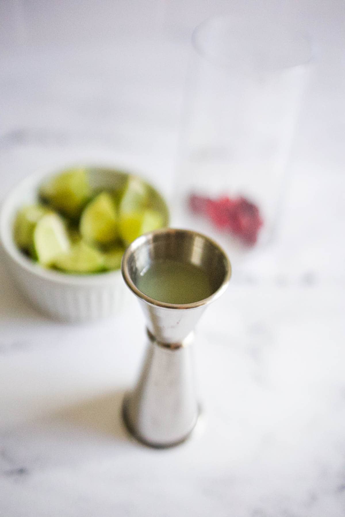 Silver jigger of lime juice Silver jigger of lime juice.