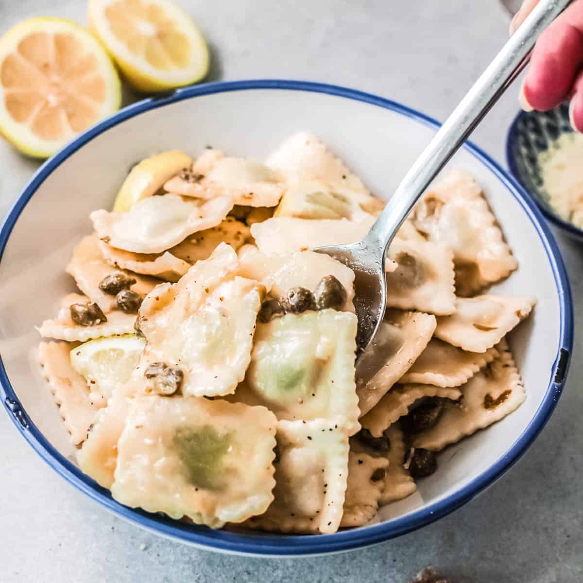 Ravioli in a bowl with a fork sticking out of it.