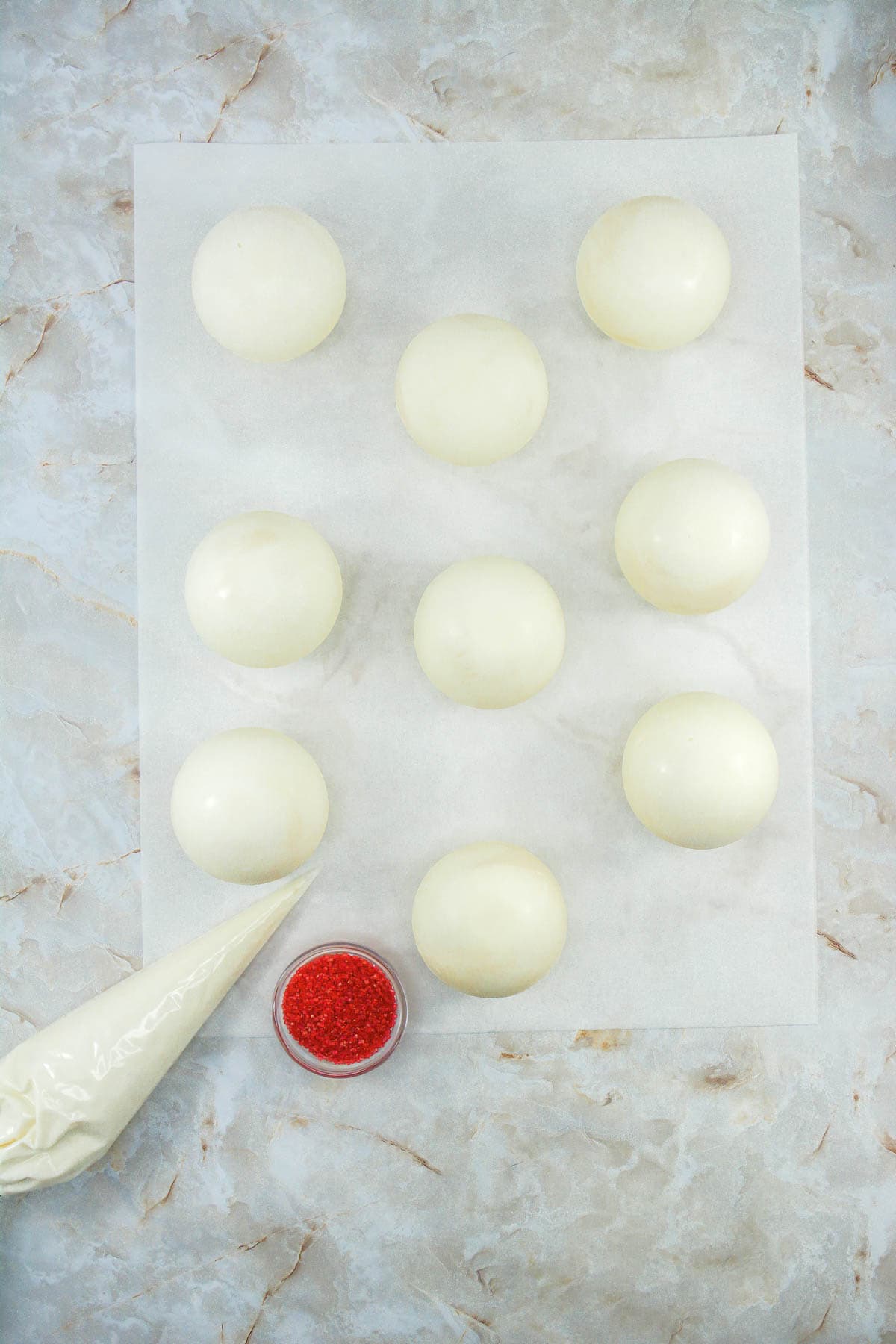 White chocolate cocoa bombs ready do be decorated.