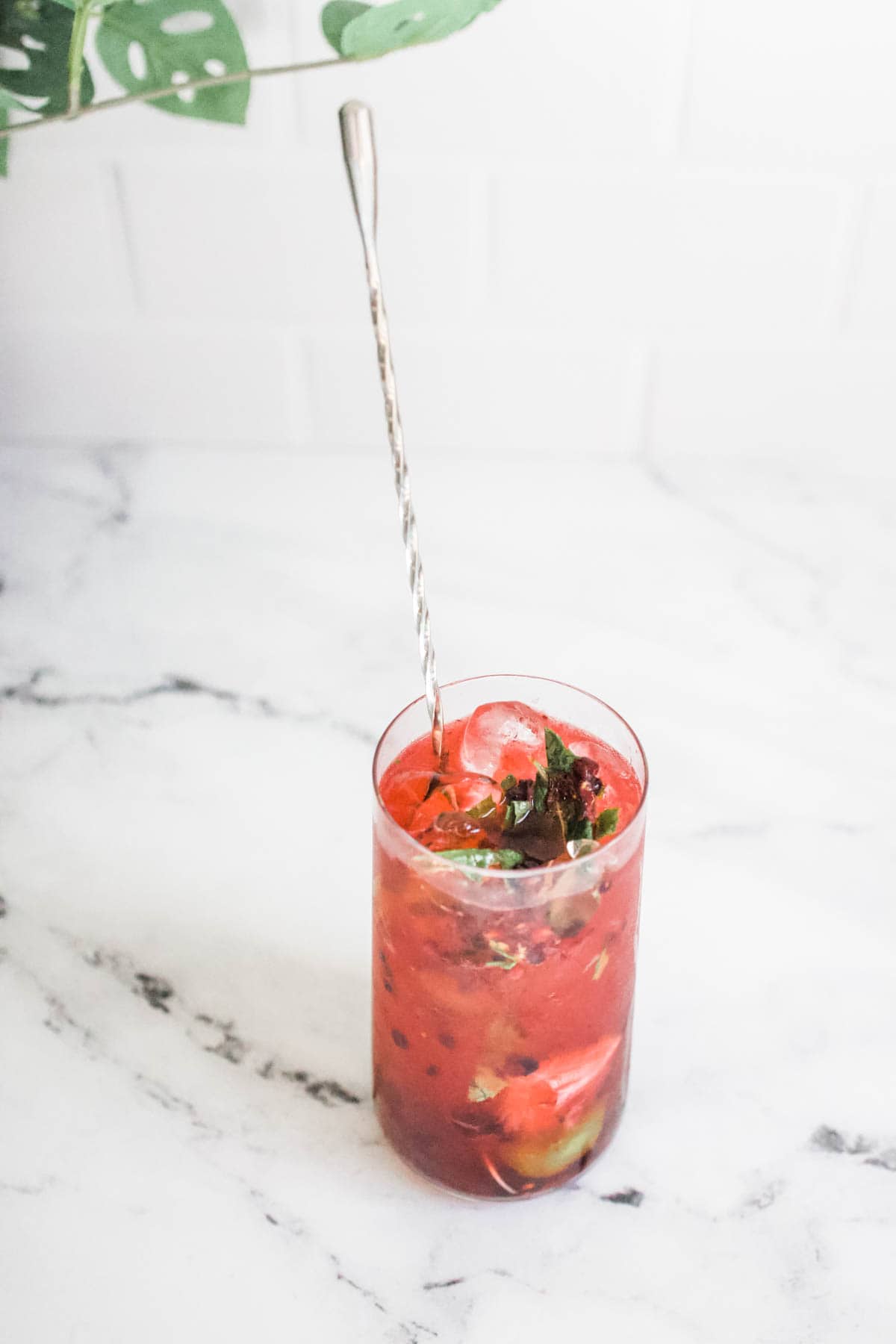 add ingredients and stir Blackberry mojito being stirred with a long metal cocktail stirrer.