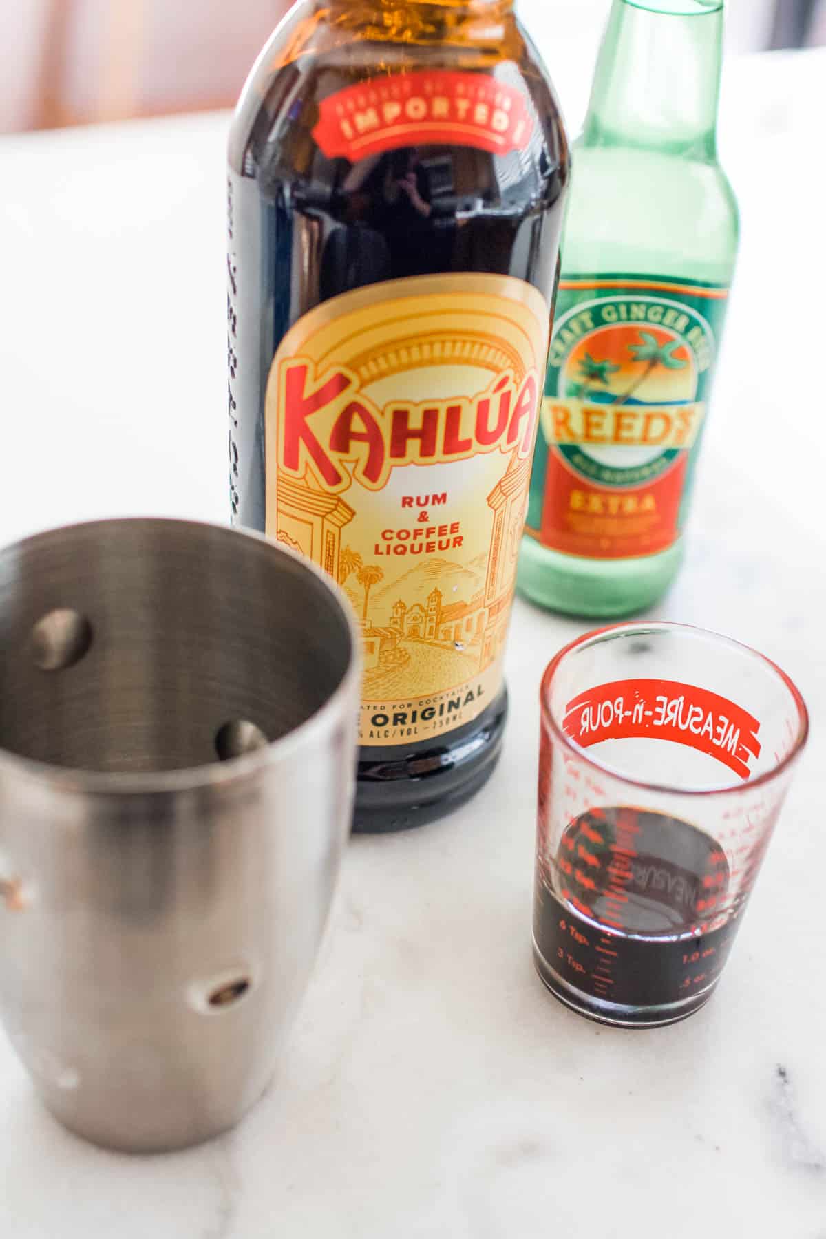 Kahula being measured next to a cocktail shaker.