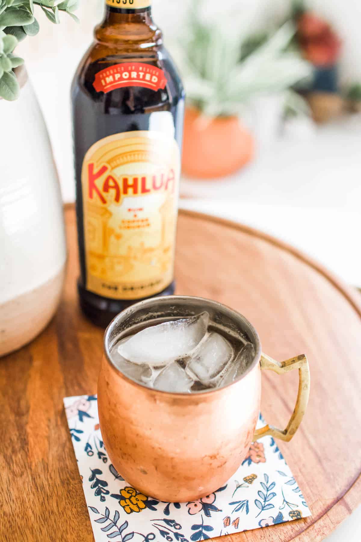 Mexican Mule in a copper mug next to a bottle of Kahlua.