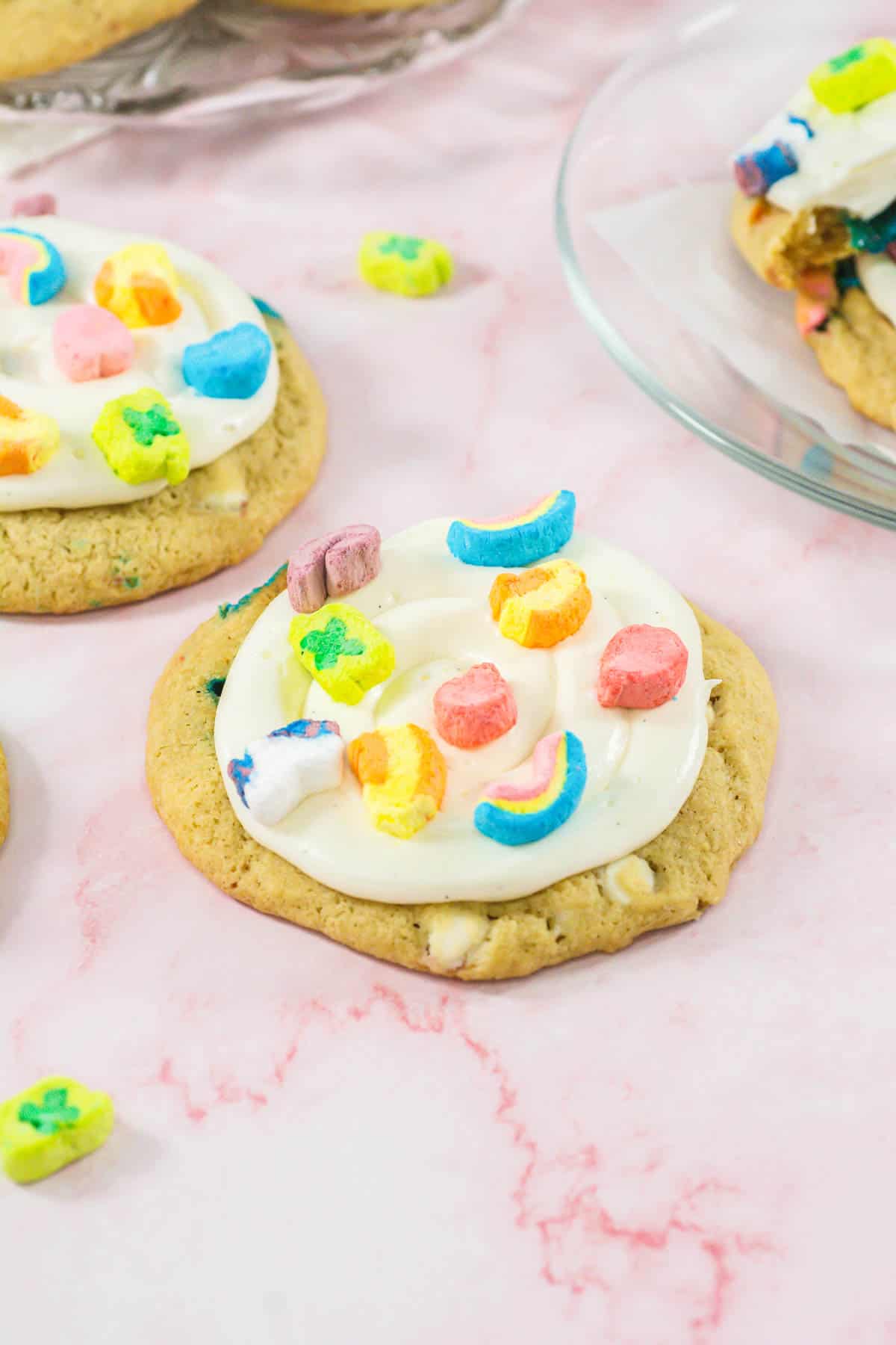 Close up of Lucky Charms Cookies on a pink marble surface.