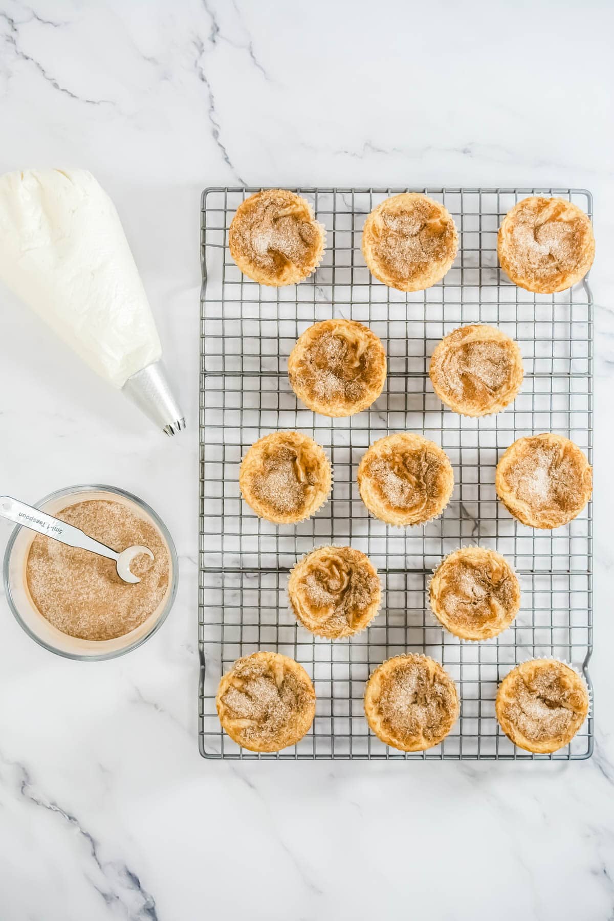 Baked RumChata cupcakes cooling on a wire rack.