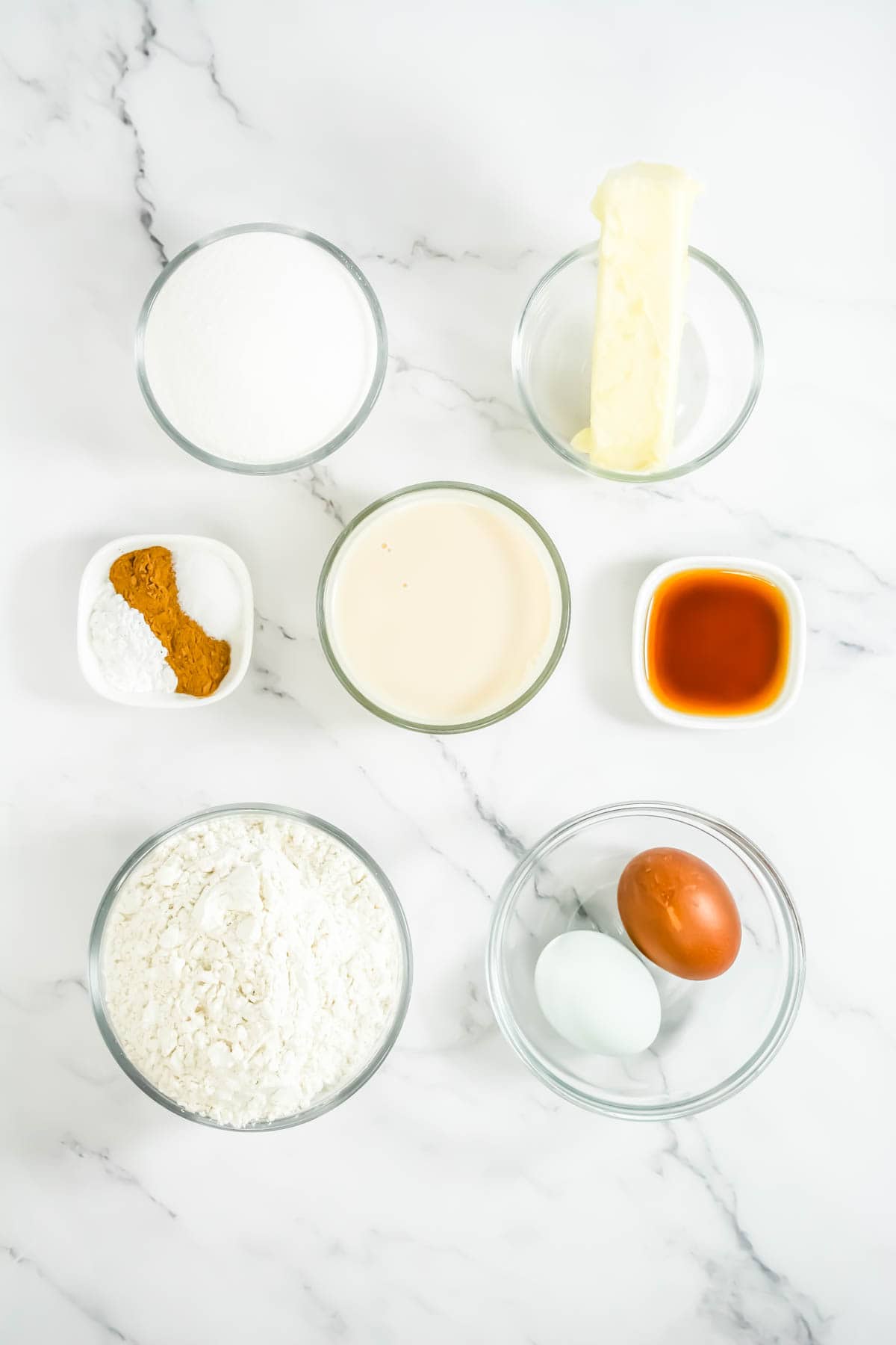 Ingredients for RumChata Cupcakes on a white marble countertop.