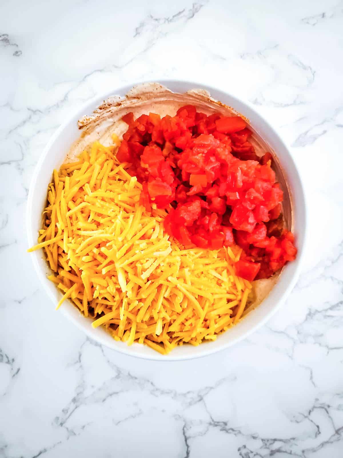 Add rotel, cheddar cheese and rotel with sour cream mixture.