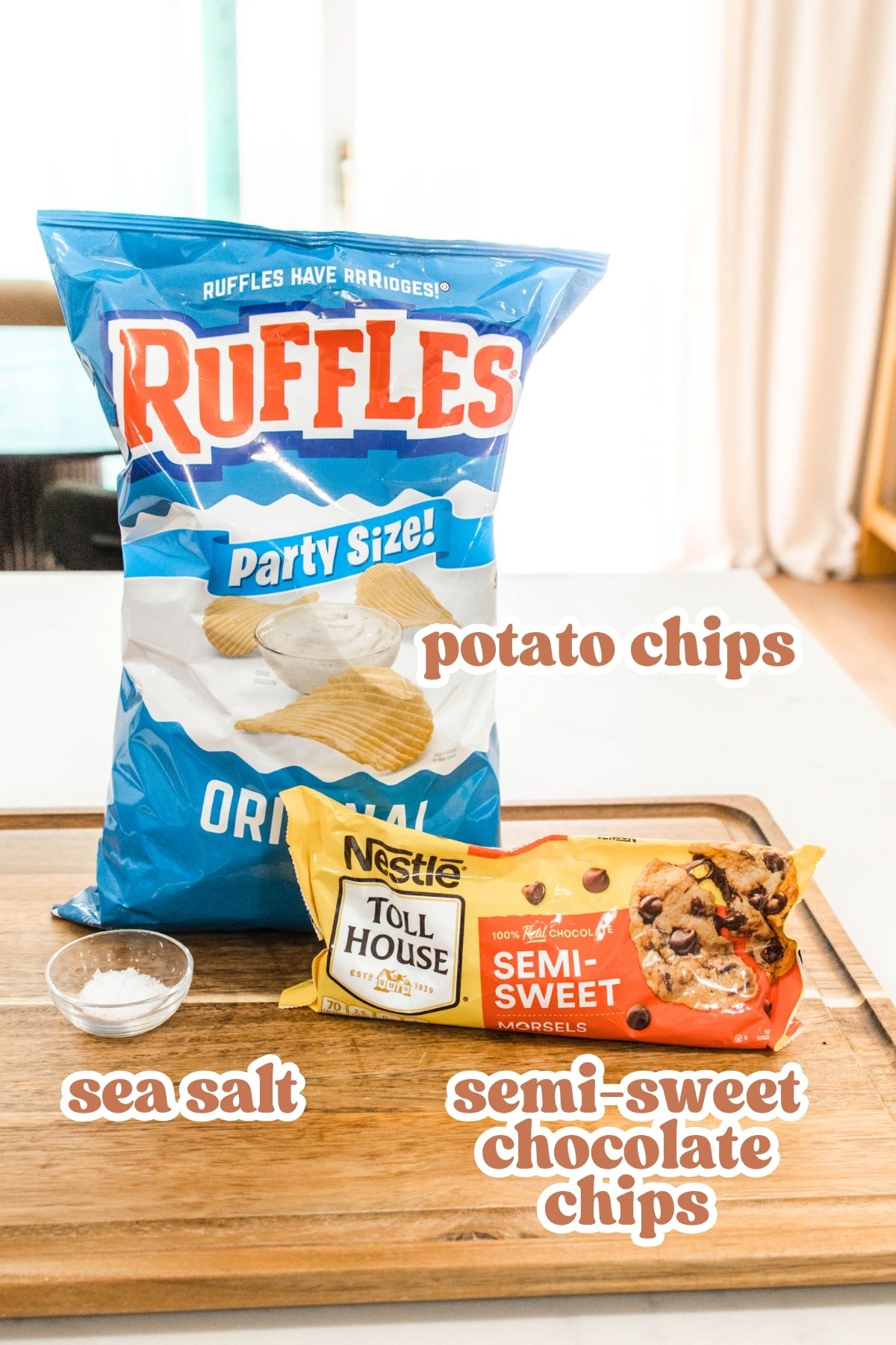 Chocolate Covered Potato Chips ingredients Text: Potato chips, semi-sweet chocolate chips and sea salt over ingredients needed for the treat.