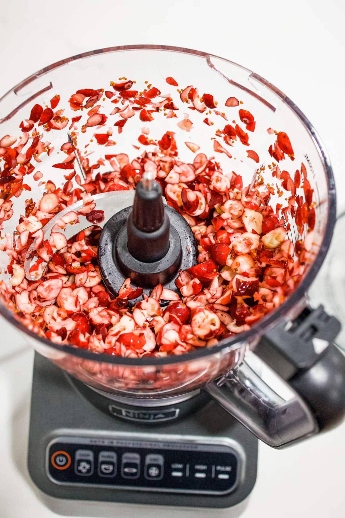 Chopped cranberries Chopped cranberries in the bowl of a food processor.