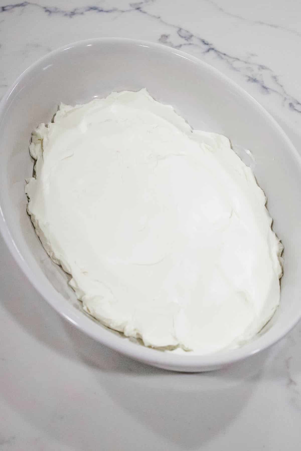 Cream cheese spread Cream cheese spread in a white serving dish for a recipe.
